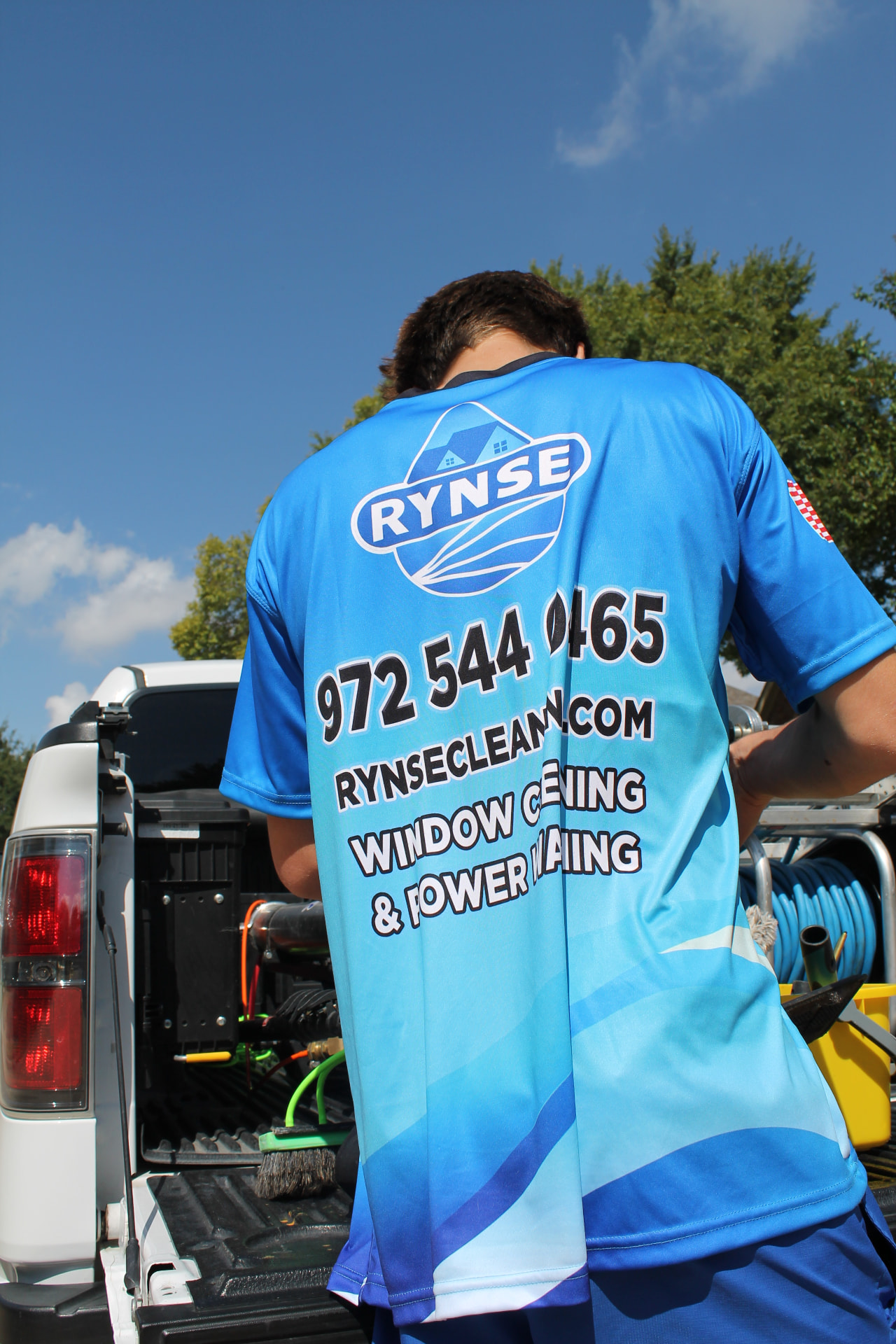 RYNSE technician preparing window cleaning equipment at the truck